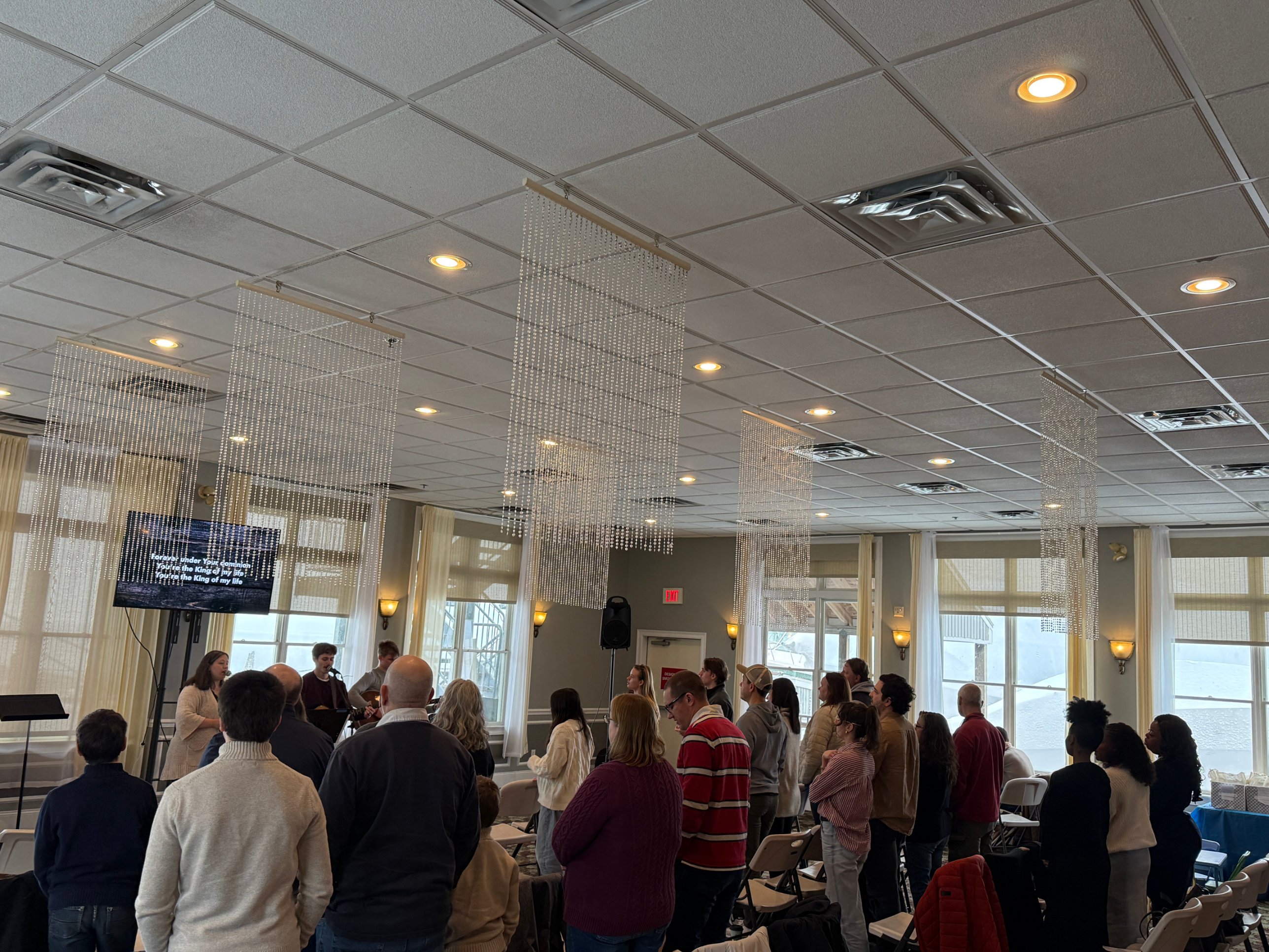 The Grace Hill congregation standing and singing together on a Sunday morning